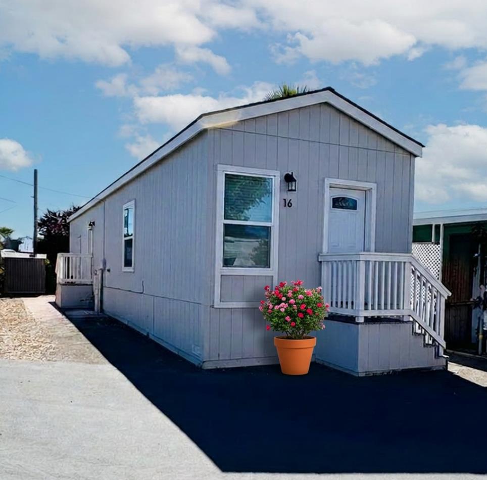Featuring light gray siding with white trim