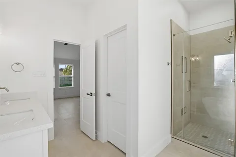 a bathroom with a shower and a sink