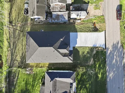 an aerial view of a house with a yard