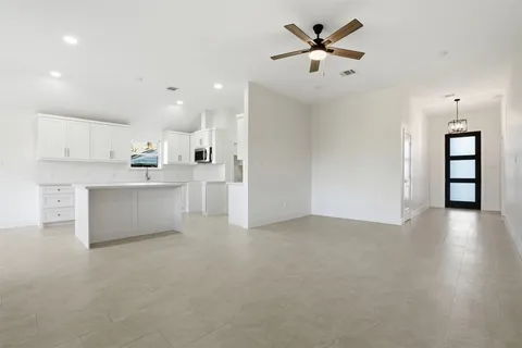 a view of a kitchen with a sink and a refrigerator