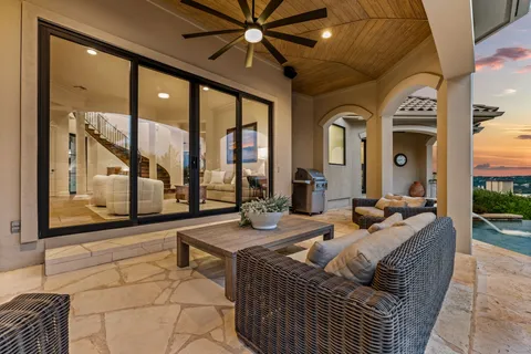 a living room with patio furniture and a large window