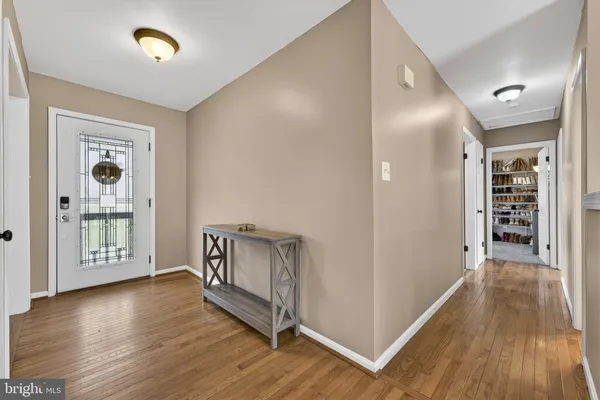 a view of hallway with wooden floor
