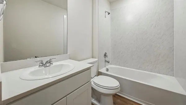 a bathroom with a sink a toilet and bathtub