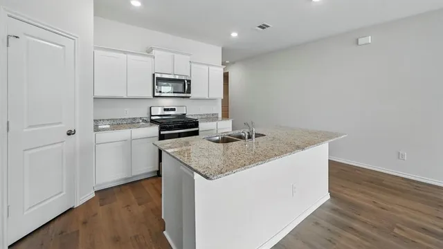 a kitchen with a sink and cabinets