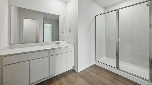 a bathroom with a double vanity sink and mirror
