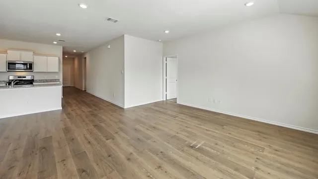 a view of kitchen dining table chairs microwave and cabinets