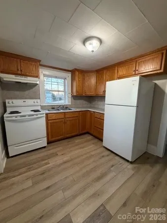 a kitchen with a cabinets and wooden floor