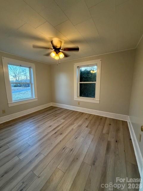 1936 Stamey Road Hudson, NC 28638 - Photo 5 of 10 an empty room with wooden floor and windows