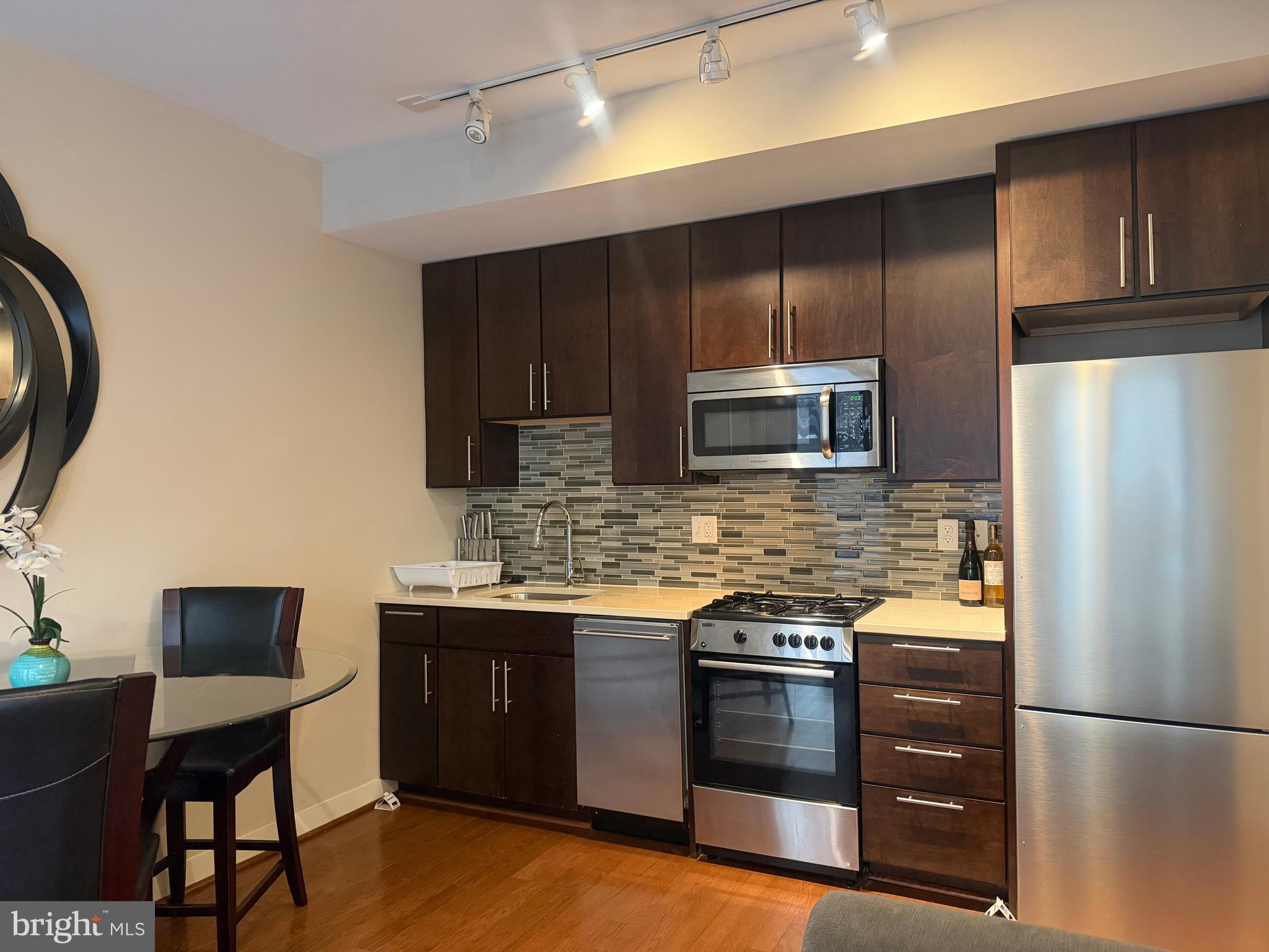 1320 Fenwick Lane, Unit 700 Silver Spring, MD 20910 - Photo 19 of 26 a kitchen with stainless steel appliances a stove a sink and a refrigerator