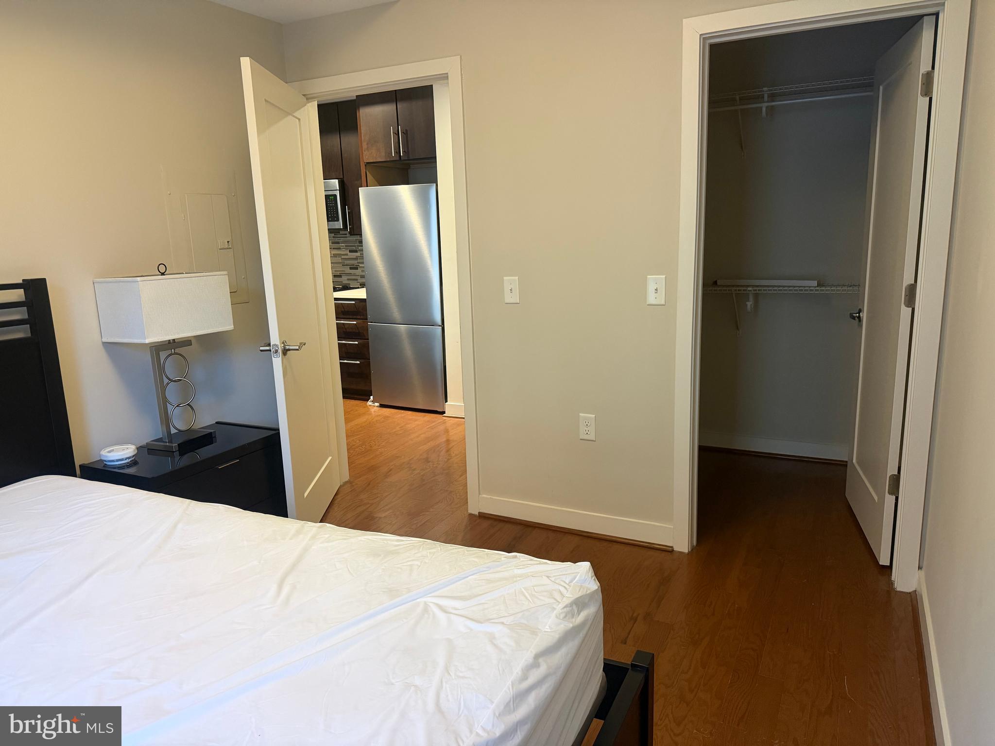 1320 Fenwick Lane, Unit 700 Silver Spring, MD 20910 - Photo 20 of 26 a bedroom with a bed and wooden floor
