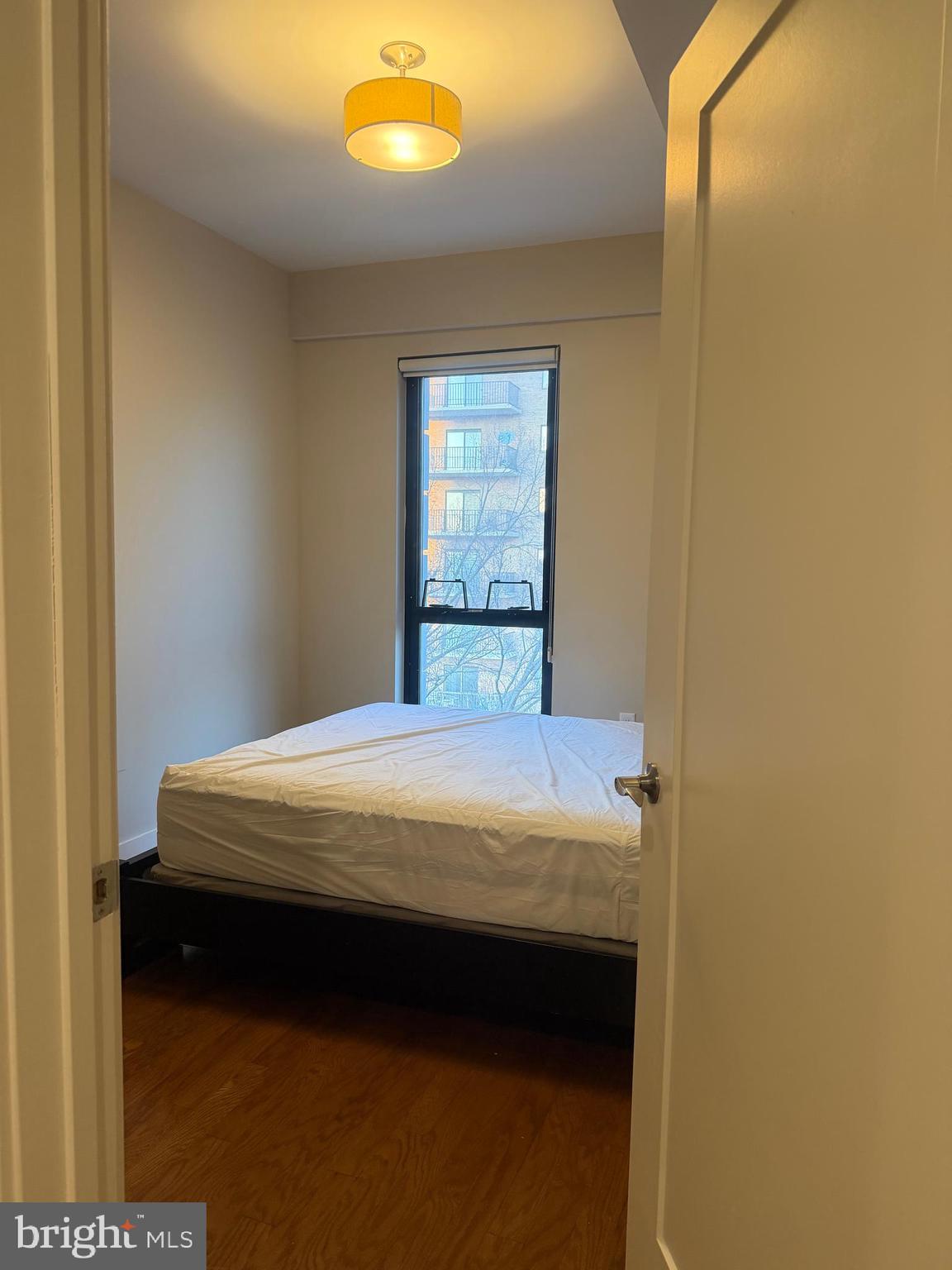 1320 Fenwick Lane, Unit 700 Silver Spring, MD 20910 - Photo 22 of 26 a bed sitting in a bedroom next to a window
