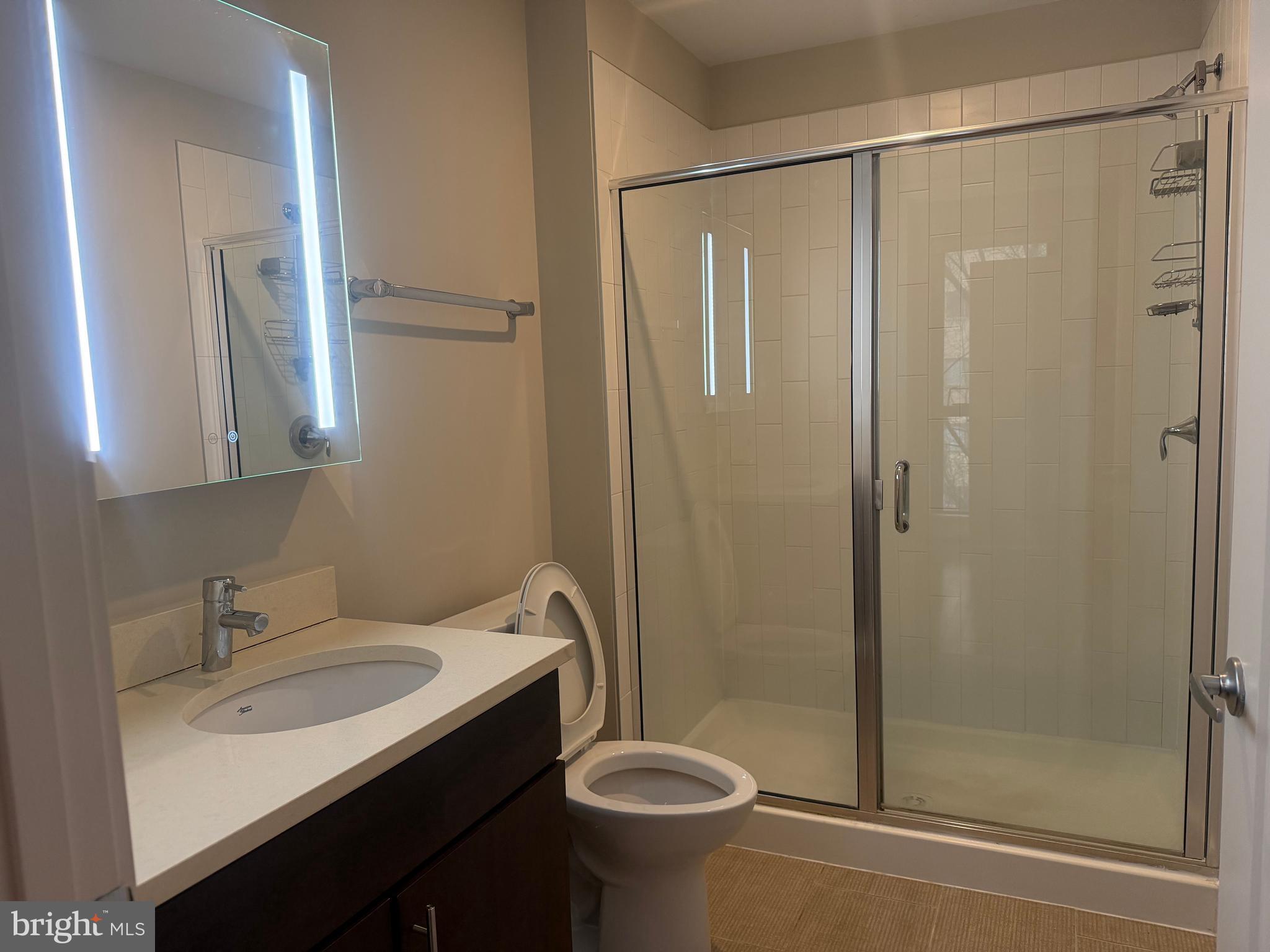 1320 Fenwick Lane, Unit 700 Silver Spring, MD 20910 - Photo 23 of 26 a bathroom with a sink toilet and shower