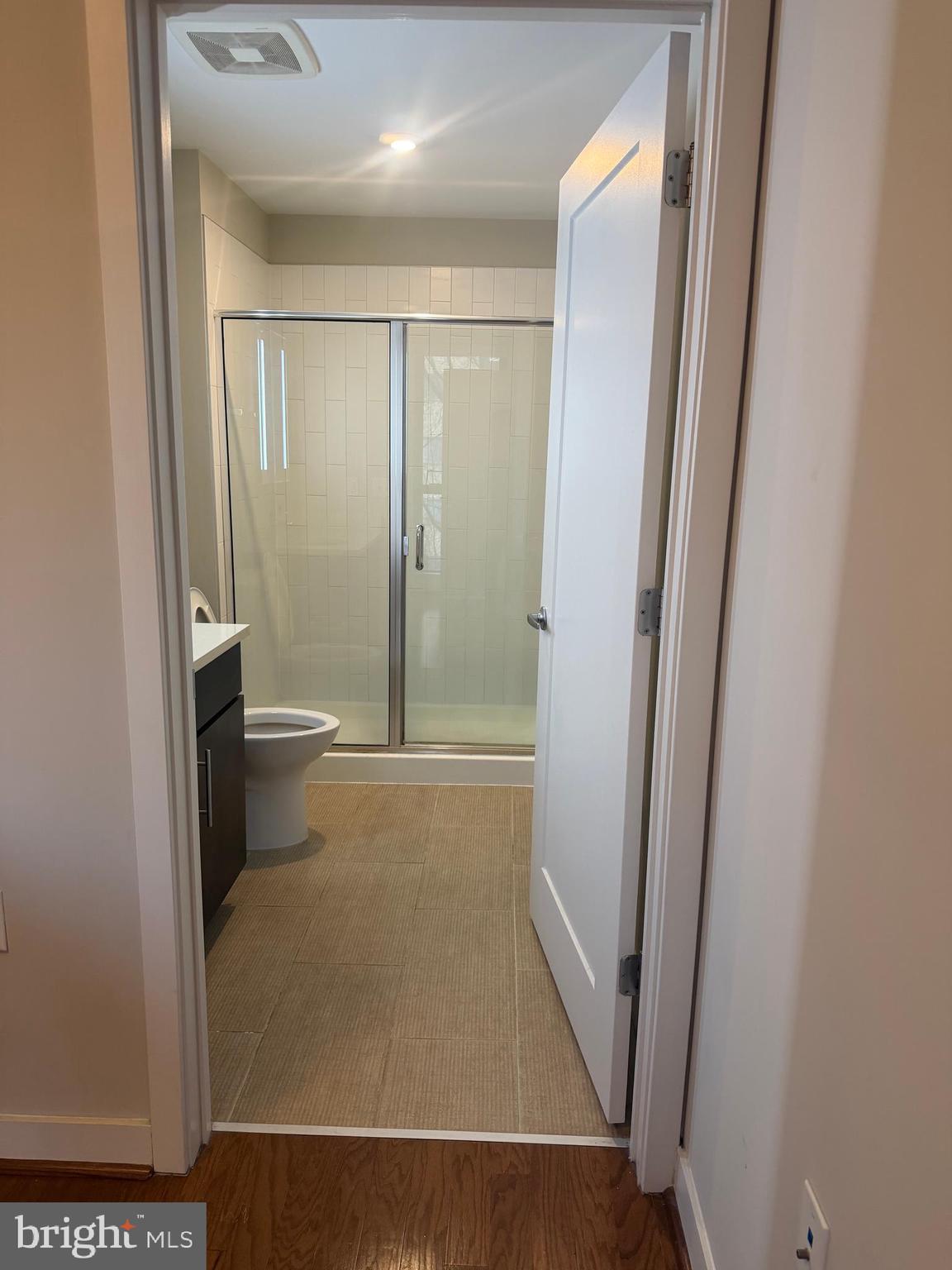 1320 Fenwick Lane, Unit 700 Silver Spring, MD 20910 - Photo 24 of 26 a bathroom with a glass door shower a toilet and a sink