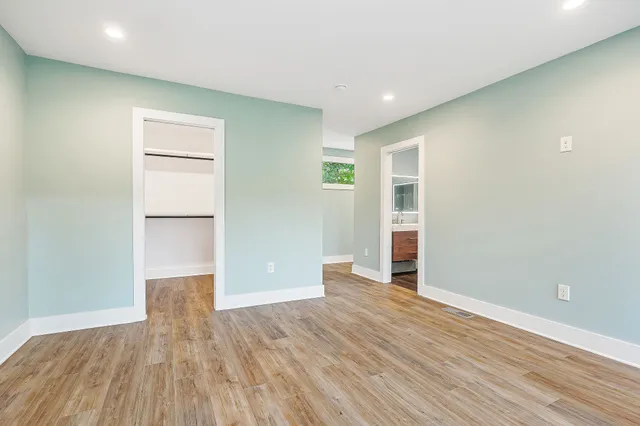 a living room with furniture and kitchen view