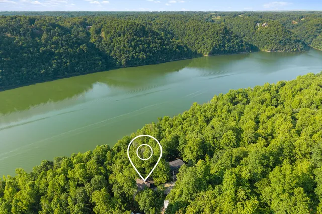 an aerial view of a house with a yard