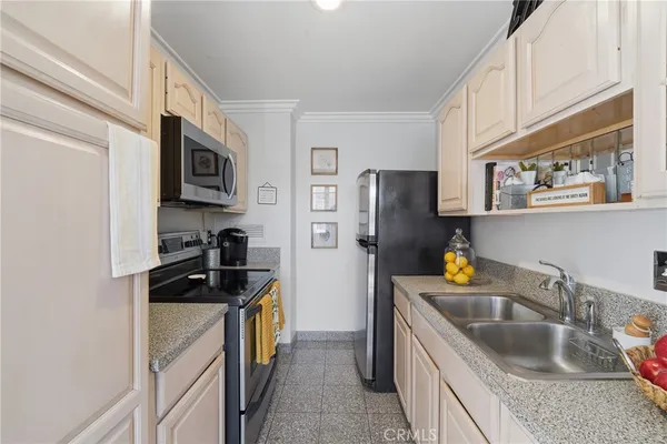 a kitchen with a refrigerator stove and sink