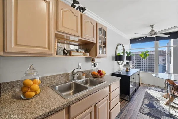 a kitchen with stainless steel appliances a sink a stove and a wooden cabinets