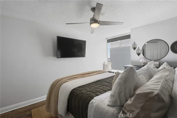 a bedroom with a bed and a flat screen tv