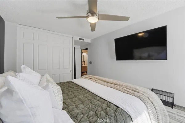 a bedroom with a flat screen tv and a bed