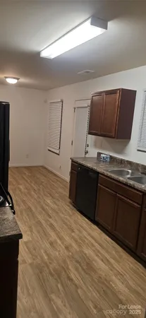 a kitchen with stainless steel appliances wooden cabinets and a sink