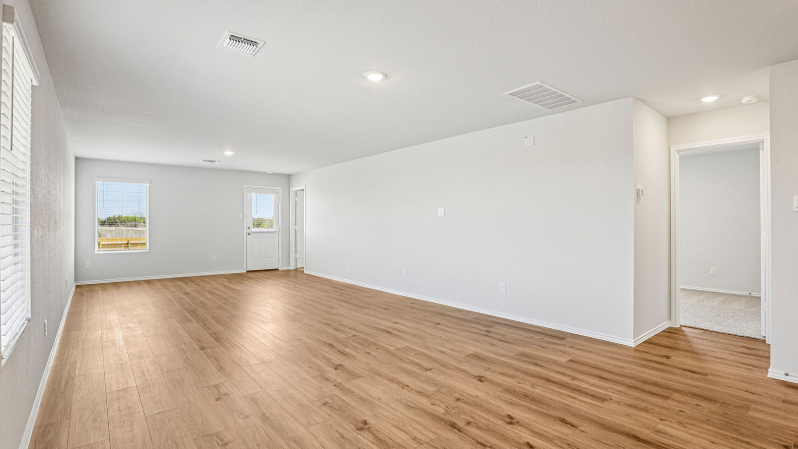 148 Wyatt Way Jarrell, TX 76537 - Photo 10 of 33 Spacious interior featuring wood-finish flooring, recessed lighting, and bright white walls