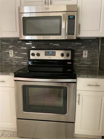 a stove top oven sitting inside of a kitchen