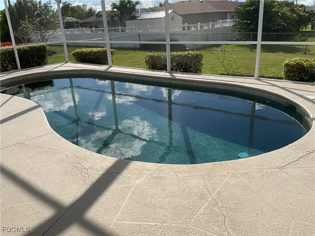 a view of swimming pool with a back yard