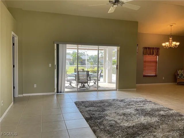 a view of a livingroom with a ceiling fan and window