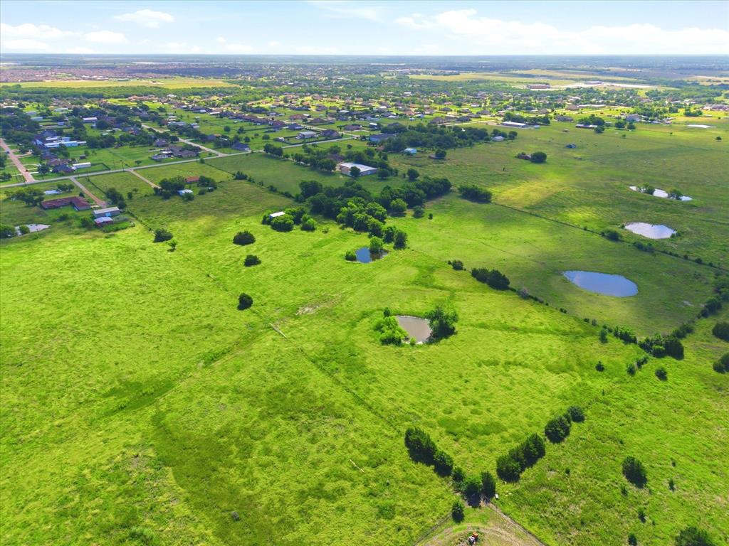 11749 Windy Lane Forney, TX 75126 - Photo 7 of 8 Expansive green acreage featuring multiple natural ponds and scattered mature trees
