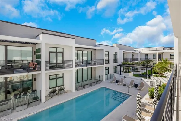a view of a house with backyard porch and sitting area
