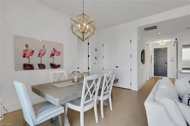 a view of a dining room with furniture and chandelier