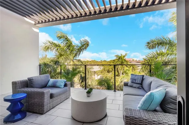 a building outdoor space with patio furniture and a potted plant