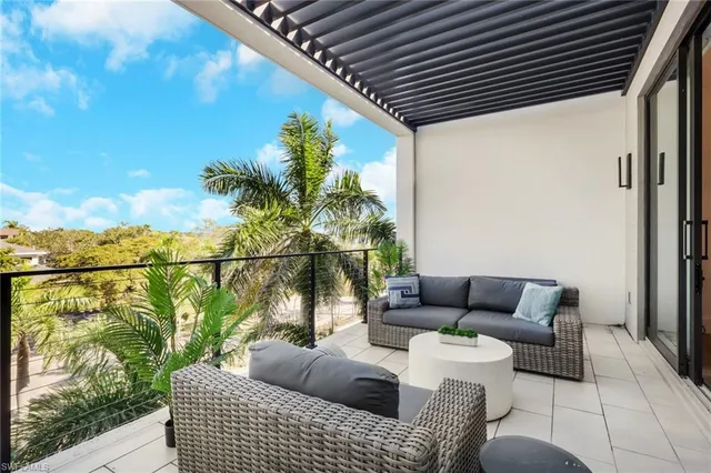a balcony with furniture and a potted plant