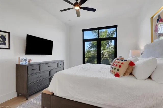 a bedroom with a bed and flat screen tv
