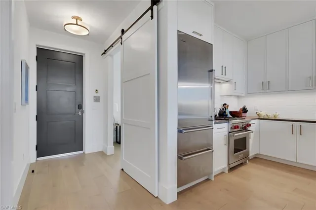 a kitchen with cabinets and stainless steel appliances