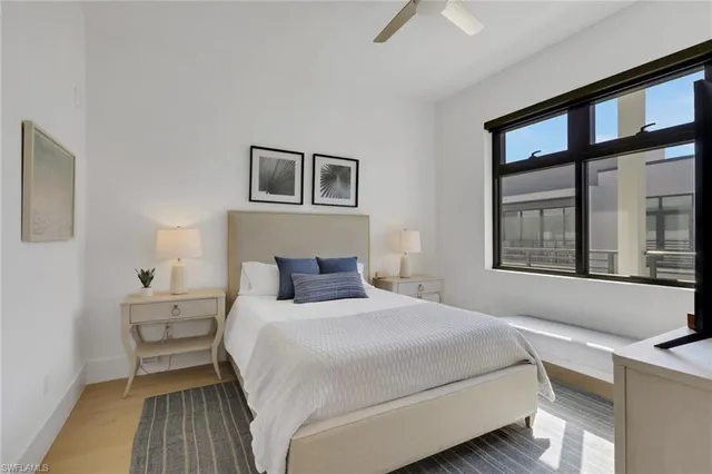 a bedroom with a bed and a large window