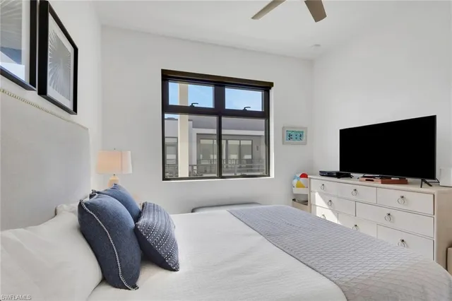 a hotel room with large window and a flat screen tv