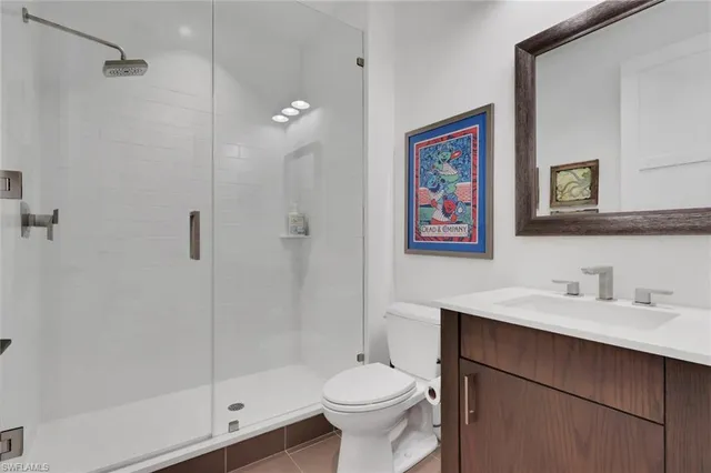 a bathroom with a toilet a sink and shower