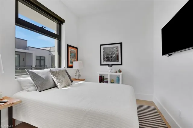 a bedroom with a large bed and a flat screen tv