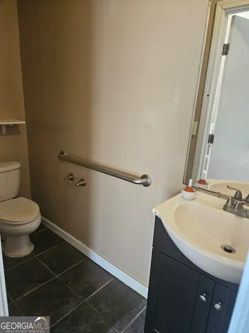 a bathroom with a sink toilet and a mirror