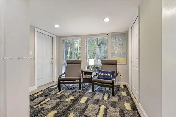 a living room with furniture and a rug