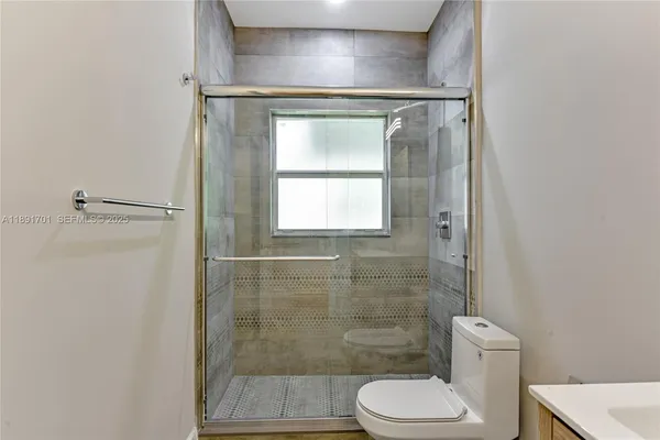 a bathroom with a toilet and a shower