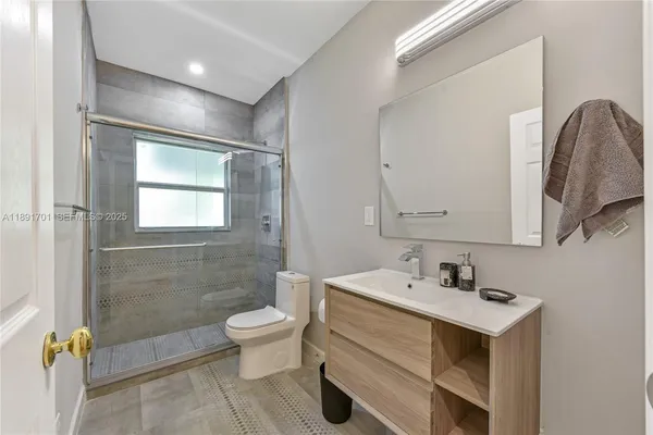 a bathroom with a sink toilet and shower