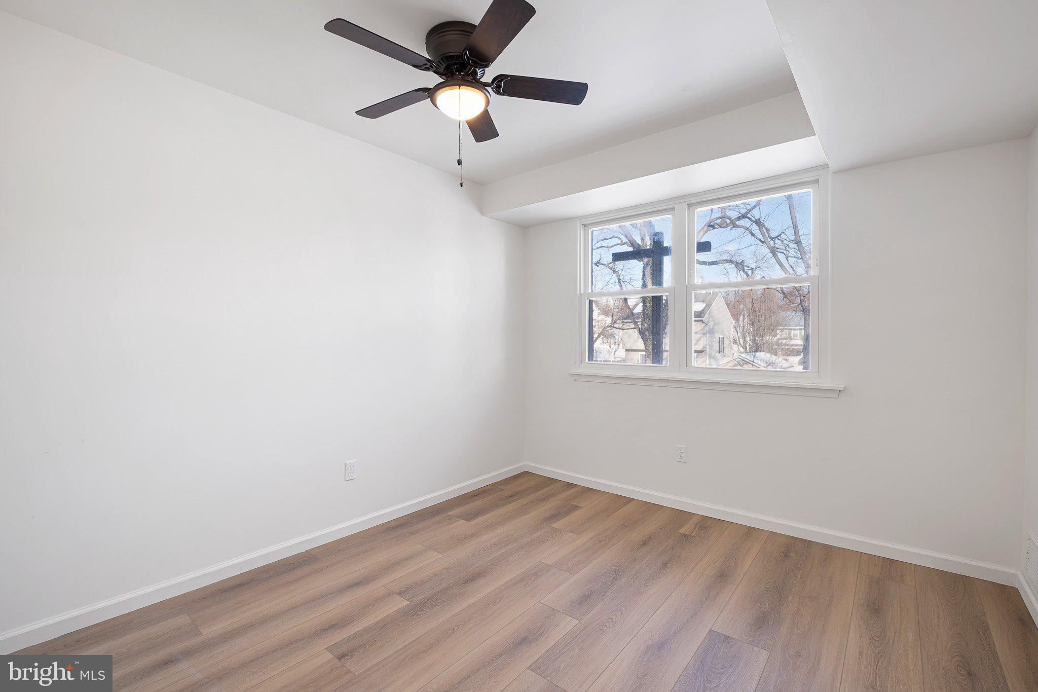 255 Prospect Avenue, Unit B Downingtown, PA 19335 - Photo 11 of 20 an empty room with wooden floor and ceiling fan
