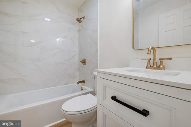 a bathroom with a sink a toilet and a bathtub