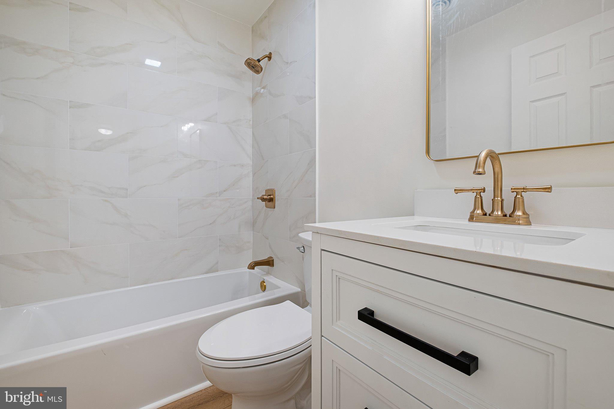 255 Prospect Avenue, Unit B Downingtown, PA 19335 - Photo 14 of 20 a bathroom with a sink a toilet and a bathtub