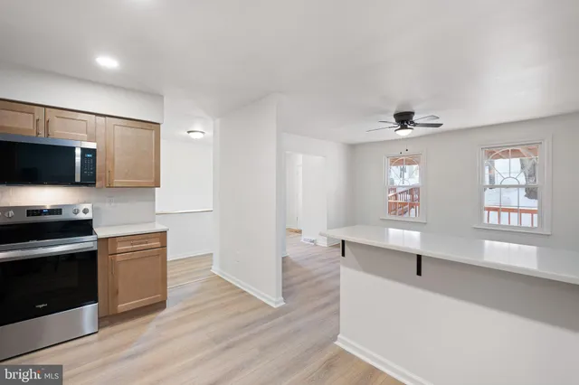 a kitchen with stainless steel appliances a stove microwave and sink