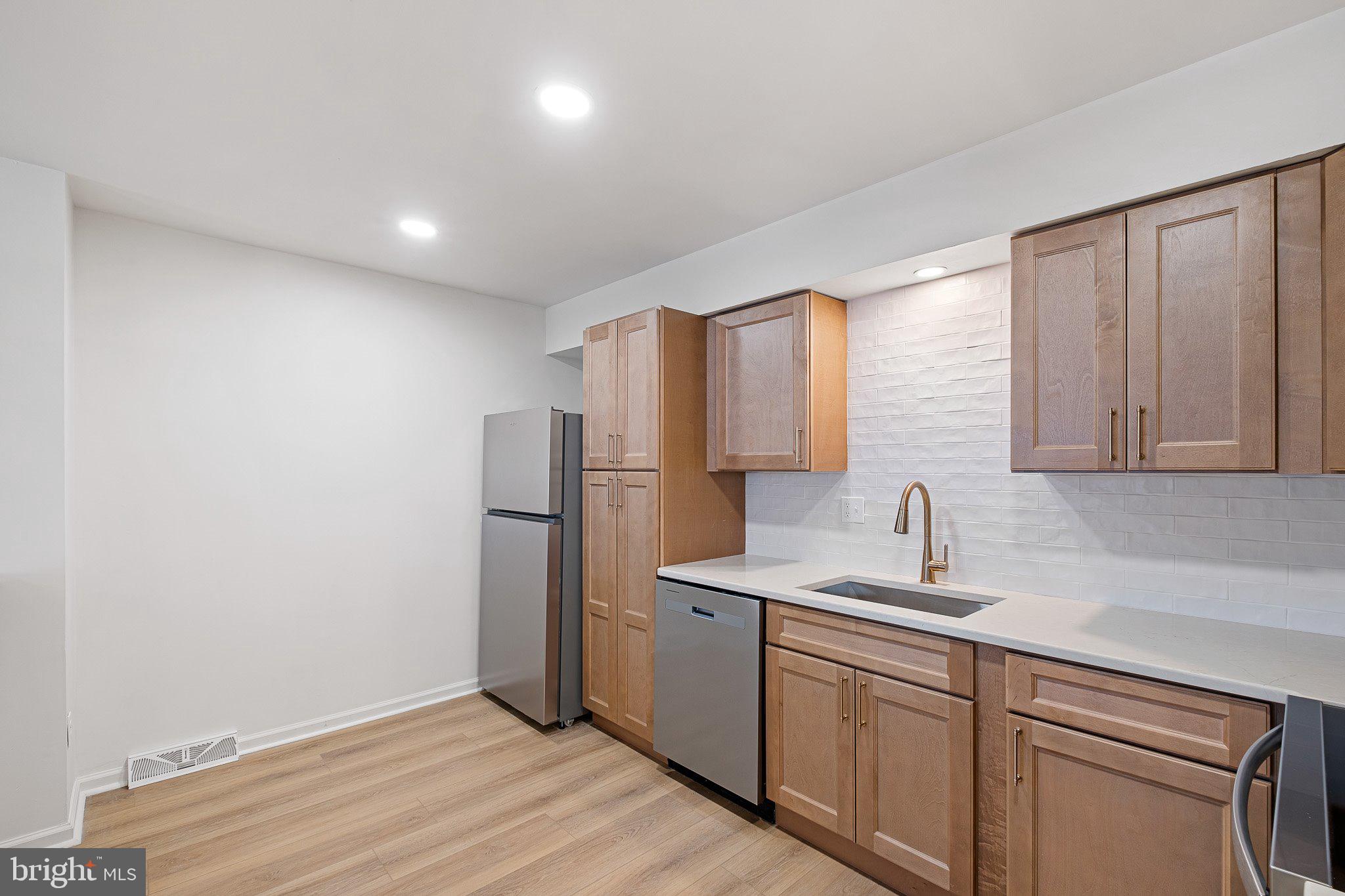 255 Prospect Avenue, Unit B Downingtown, PA 19335 - Photo 6 of 20 a kitchen with a sink cabinets stainless steel appliances and a window