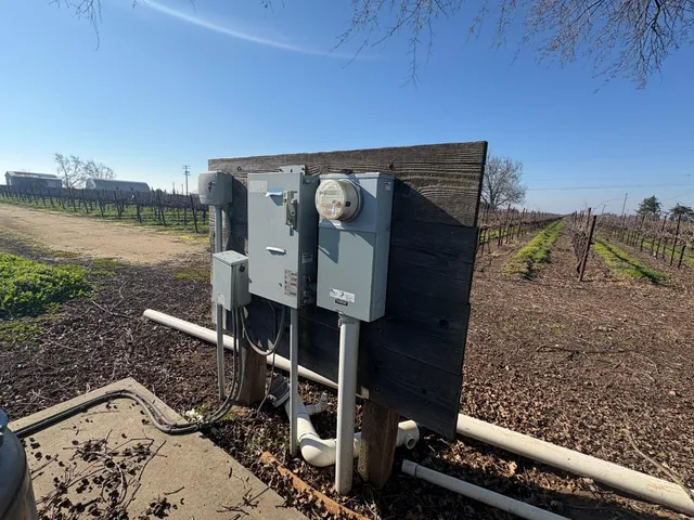 a view of a water fountain in a yard next to a lake