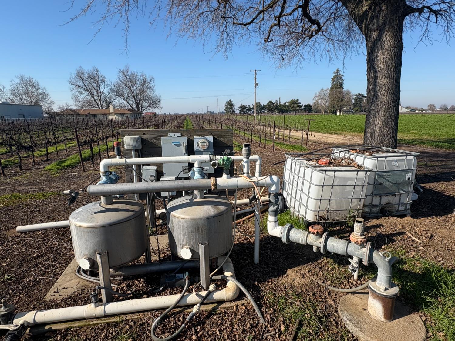 15910 North Locust Tree Road Lodi, CA 95240 - Photo 21 of 24 a view of a chairs and table in patio with a lake view